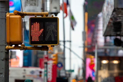 View of road sign on street in city