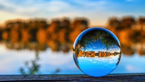 Close-up of crystal ball against blue sky