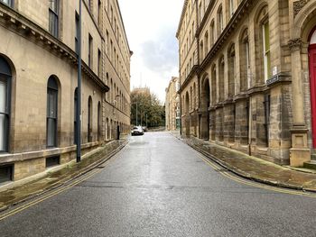View down, vicar lane, with victorian stone built mill buildings in, little germany, bradford, uk