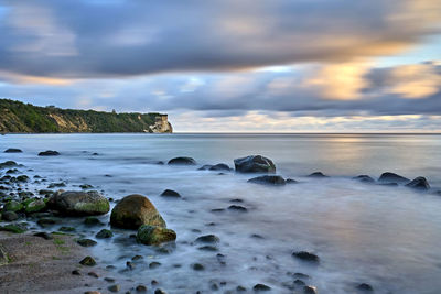 Rocks on beach against sky