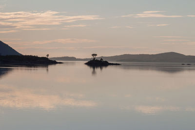 Scenic view of lake against sky during sunset