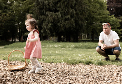 Portrait of a baby girl with her father in the park.