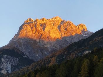 Low angle view of rocks on mountain against sky