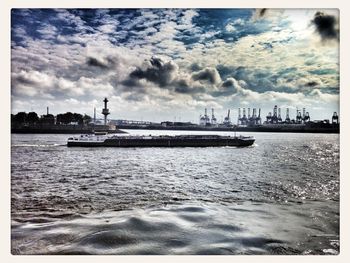 Scenic view of sea against cloudy sky