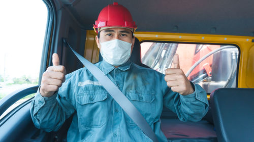 Portrait of man working in car