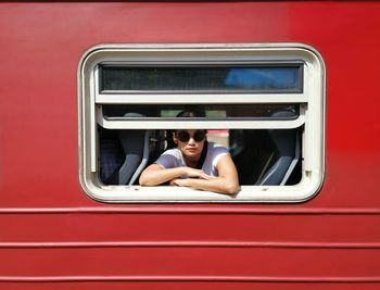 Portrait of woman looking through train window