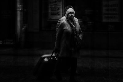 Full length of man walking on street in city