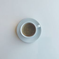 High angle view of coffee cup on white background