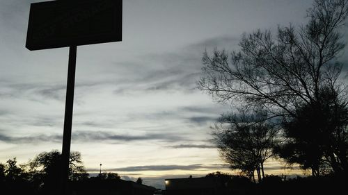 Low angle view of silhouette trees against sky