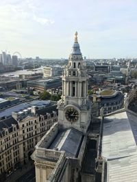 Aerial view of buildings in city against sky