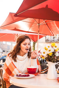 Woman having dessert at restaurant