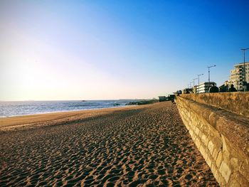 Scenic view of beach against clear blue sky