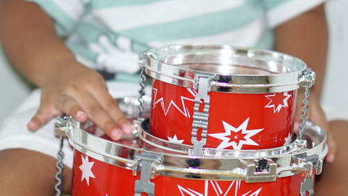 Midsection of boy with drums