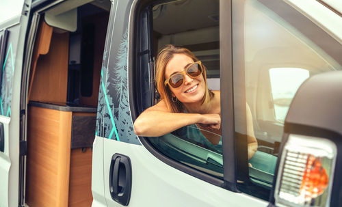 Portrait of young woman in car