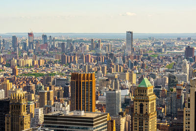 High angle view of modern buildings in city against sky