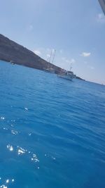Sailboat in sea against sky