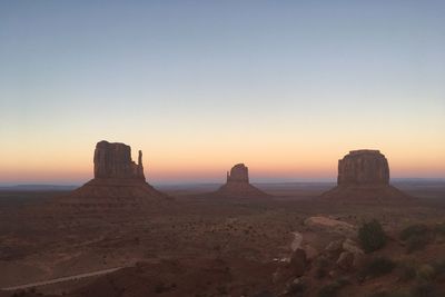 Scenic view of rock formation against clear sky during sunset