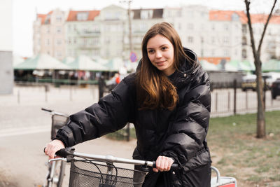 Woman wheeling with bicycle