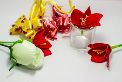 Close-up of red roses on white table