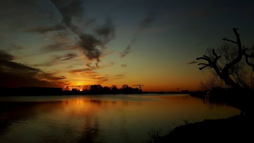 Scenic view of lake against orange sky