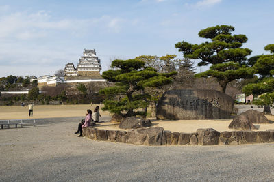 People at temple against sky