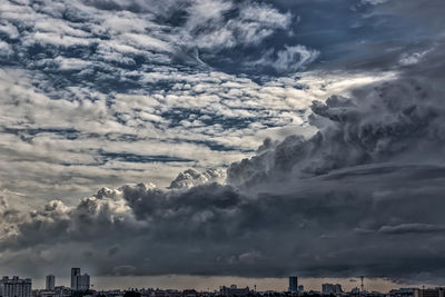 Low angle view of storm clouds over city