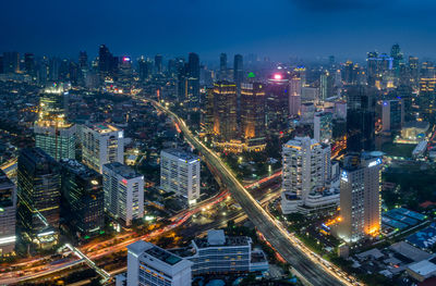 High angle view of illuminated city buildings at night