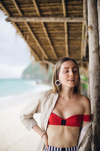 Young woman standing on beach