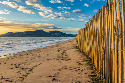 Scenic view of beach against sky during sunset