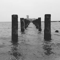 Wooden posts on pier at beach