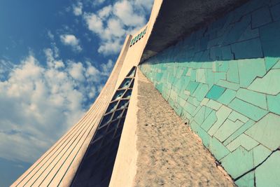 Low angle view of building against cloudy sky