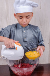 Boy preparing food in kitchen