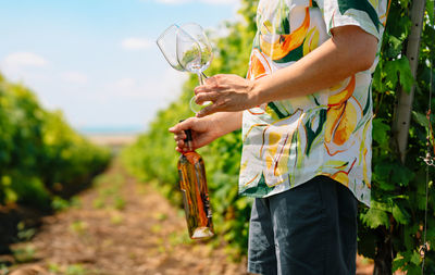 Midsection of man holding plant