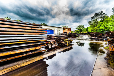 Reflection of building on lake against sky