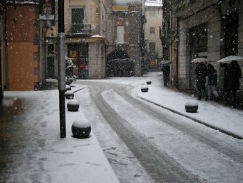 Snow covered road in city