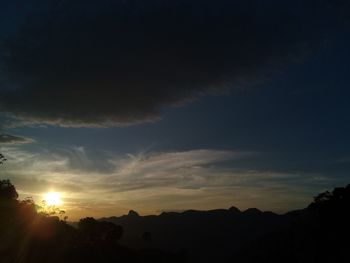 Scenic view of silhouette mountains against sky at sunset