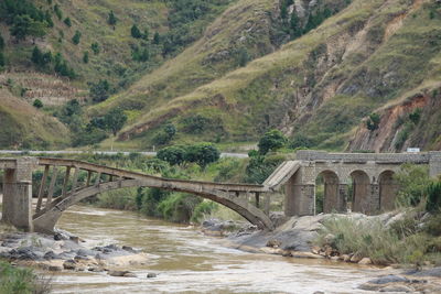Bridge over river with mountain in background