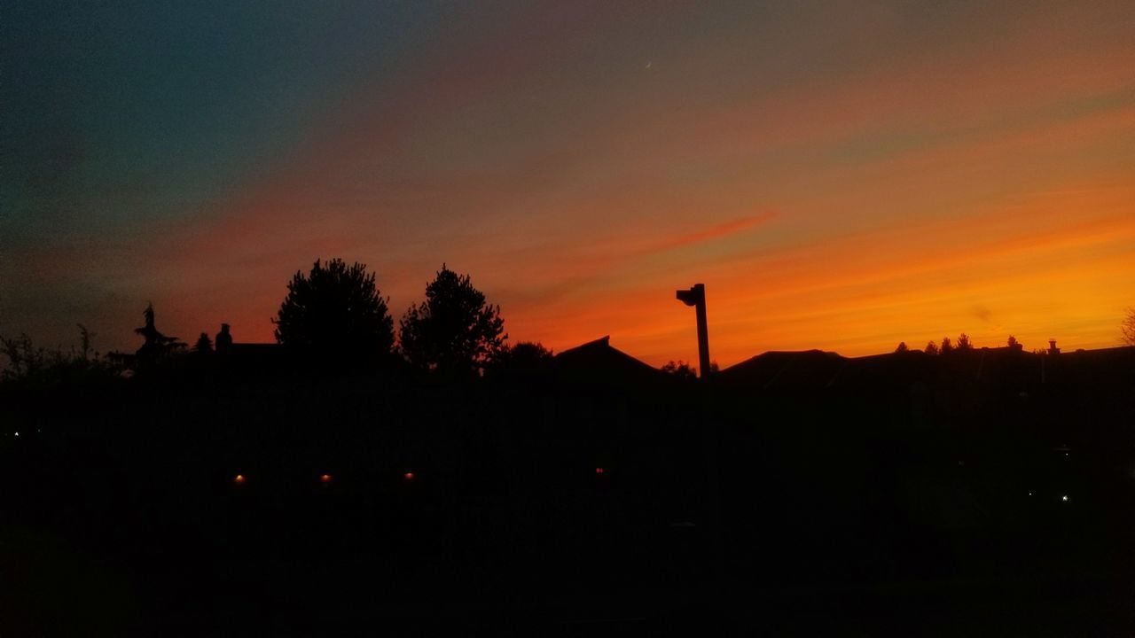 SILHOUETTE LANDSCAPE AGAINST ORANGE SKY