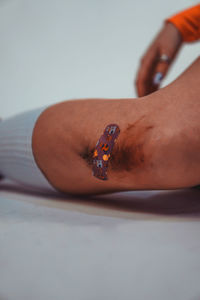 Low section of person wearing shoes on table