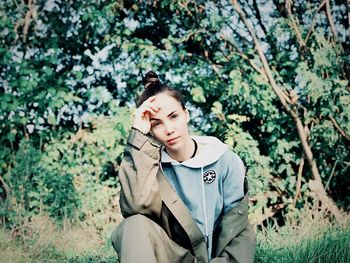 Portrait of beautiful young woman lying on land