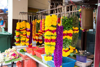 Multi colored flower pots for sale at market stall