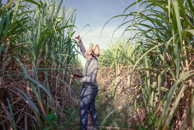 Man standing on field against sky