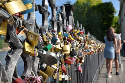 Padlocks hanging on railing in city