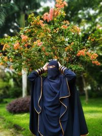 Rear view of person standing on field