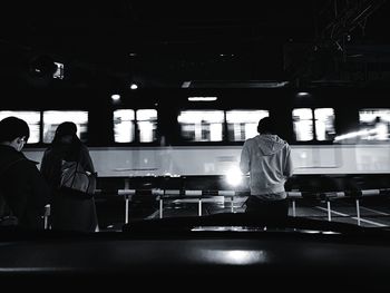 Rear view of people standing in restaurant