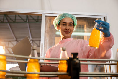 Portrait of smiling young woman holding ice cream