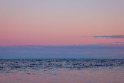 Scenic view of sea against romantic sky at sunset