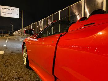 Red car on street at night