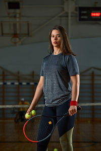 Portrait of young woman standing in gym