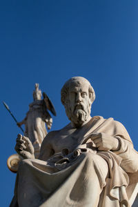 Low angle view of statue against clear blue sky